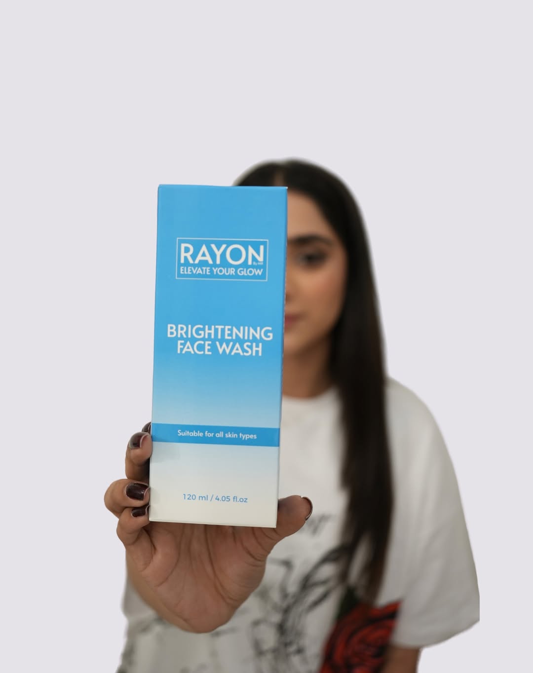 Model holding RayonbyMR's Brightening Face Wash in front of her with a white background